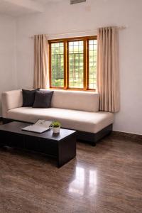 a living room with a couch and a coffee table at Casa Horizon in Sultan Bathery