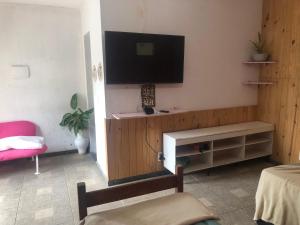 a living room with a flat screen tv on the wall at Casa da mãe joanna in Guapimirim