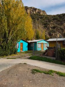 a group of small houses in front of a mountain at Flor Austral in Chile Chico