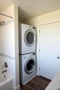 a washer and dryer in a bathroom next to a door at The Lindon House in Lindon