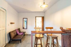 a living room with a wooden table and chairs at La cabaña del Búho in Cali