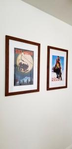 three framed pictures on a white wall at The Lindon House in Lindon