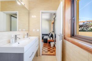 a bathroom with a sink and a mirror at Maia Oporto Suites in Maia +122 photos