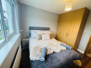a small bedroom with a bed with a blanket on it at Duchess Victoria Haven in Drogheda