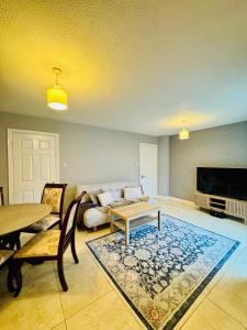 a living room with a couch and a table at Duchess Victoria Haven in Drogheda