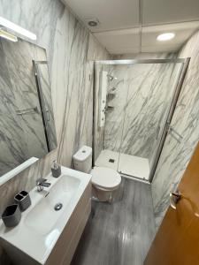 a bathroom with a sink and a toilet and a shower at A la Orilla del Mar in Matalascañas +178 photos