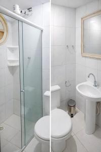 a white bathroom with a toilet and a sink at Pousada Casarão Piúma in Piúma +8 photos