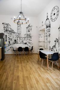 a dining room with a table and chairs and a clock at FiveHostel in Krakow