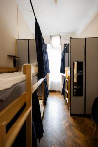 a room with two bunk beds and a window at FiveHostel in Krakow