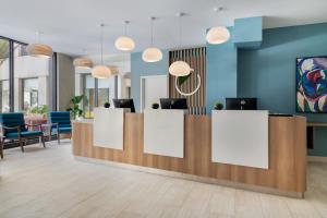 an office lobby with a reception desk and chairs at Element by Marriott New Orleans Downtown in New Orleans