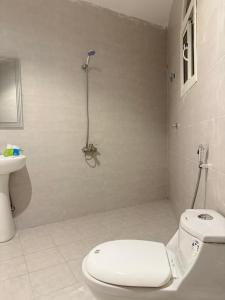 a bathroom with a toilet and a shower in it at comfortable hotel in Jeddah