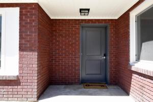 a brick wall with a door and a window at The Lindon House in Lindon