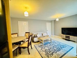 a living room with a table and a couch at The Emerald Prince Alcove in Drogheda