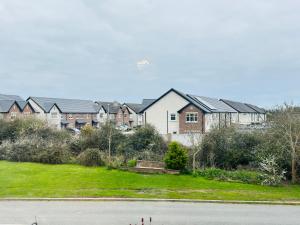a row of houses on a hill with grass and a street at The Emerald Prince Alcove in Drogheda