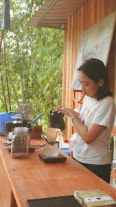 a woman standing at a table with a blender at Tetebatu Hideaway in Tetebatu +34 photos
