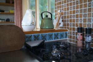 a kitchen counter with a tea kettle on a stove at salvia blue in Miyazaki +65 photos