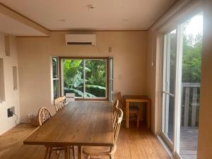 a dining room with a wooden table and chairs at salvia blue in Miyazaki