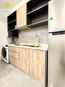 a kitchen with a sink and a refrigerator at Imperio Residences Private Bathtub or Jacuzzi by Nestcove in Malacca