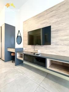 a living room with a television on a wall at Imperio Residences Private Bathtub or Jacuzzi by Nestcove in Malacca