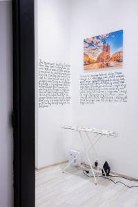 a white table in a room with a picture on a wall at FiveHostel in Krakow