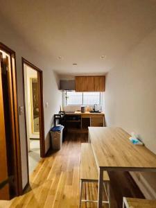 a kitchen with a wooden table in a room at 一休居 in Osaka