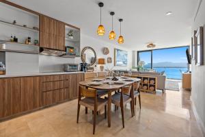 a kitchen and dining room with a table and chairs at Zantamar - Beachfront Suites in La Cruz in Cruz de Huanacaxtle