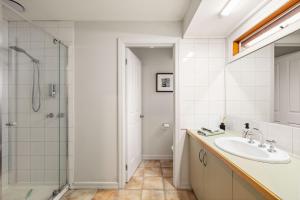 a bathroom with a sink and a shower at Beach House Silverleaves in Cowes +10 photos
