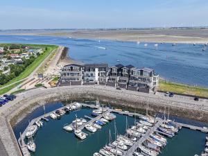an aerial view of a marina with boats in the water at Penthouse with beach view in Sint Annaland