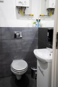 a bathroom with a white toilet and a sink at Fivehostel in Krakow +27 photos