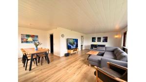 a living room with a couch and a table at 4 Bedrooms Cozy & Spacious Villa - Lalandia & Puttagrden & Femern in Rødby