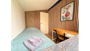 a small bedroom with a bed and a desk at 4 Bedrooms Cozy & Spacious Villa - Lalandia & Puttagrden & Femern in Rødby