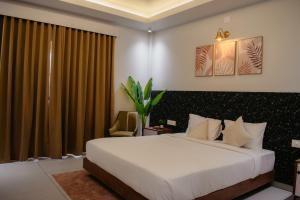 a hotel room with a bed and a window at Horizon Nest in Agatti +10 photos