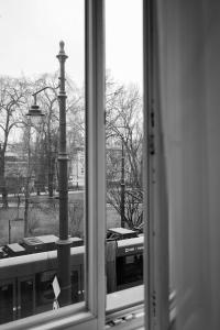 a window with a view of a street light and a train at Fivehostel in Krakow