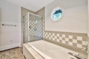 a bathroom with a tub and a glass shower at Minnow's Run in Kings Beach