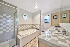 a bathroom with a tub and a sink at Minnow's Run in Kings Beach