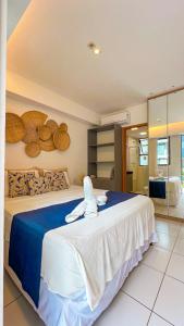 a bedroom with a large bed with two stuffed animals on it at Reserva Muro Alto - Makia Beach Experience in Porto De Galinhas +54 photos