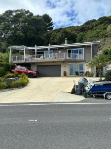 a house with a car parked in front of it at Te Mata Bay Seaviews in Tapu