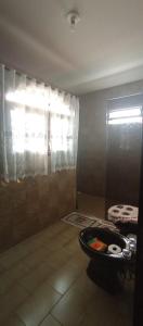 a bathroom with a tub in a room with a window at Casa Quarto 2 in Jaraguá do Sul