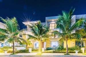 a building with palm trees in front of it at Villa FLC Sầm Sơn Thanh Hoá in Sầm Sơn