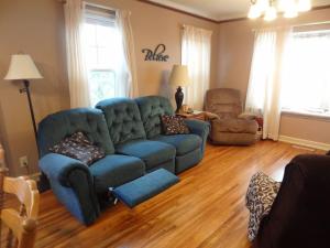 a living room with a blue couch and a chair at 2 Blks St Marys 2 Main Fl Beds Bath CoveredByFaith in Rochester