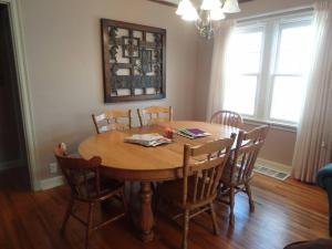 a dining room table with chairs and a wooden table at 2 Blks St Marys 2 Main Fl Beds Bath CoveredByFaith in Rochester