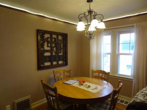 a dining room with a table and chairs and a window at 2 Blks St Marys 2 Main Fl Beds Bath CoveredByFaith in Rochester