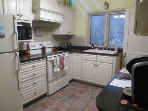 a kitchen with white cabinets and white appliances at 2 Blks St Marys 2 Main Fl Beds Bath CoveredByFaith in Rochester +15 photos