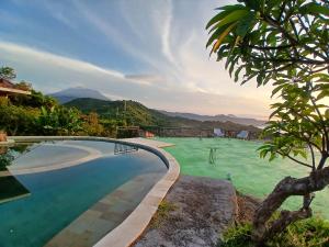 a swimming pool with a view of the mountains at Yoga bale house3 in Padangbai