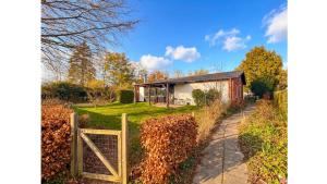 a wooden gate in front of a house at 4 Bedrooms Cozy & Spacious Villa - Lalandia & Puttagrden & Femern in Rødby