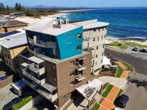 an aerial view of a building with the ocean in the background at The Dorsal Boutique Hotel in Forster