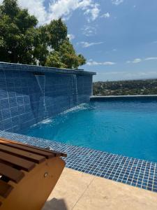 a swimming pool with a bench in front of it at Hillside Haven in Kingston +14 photos