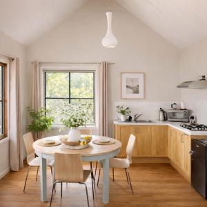 a kitchen with a table and chairs in a kitchen at Balingup Highview Chalets in Balingup