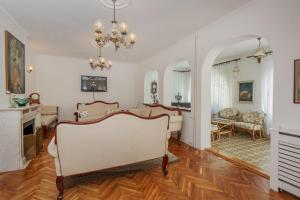 a living room with white walls and wooden floors at Villa Paradiso in Donji Morinj