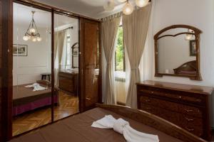 a bedroom with a mirror and a bed and a dresser at Villa Paradiso in Donji Morinj +54 photos